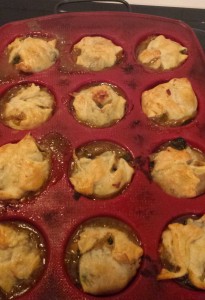 A muffin pan filled with mini pot pies. Yum.